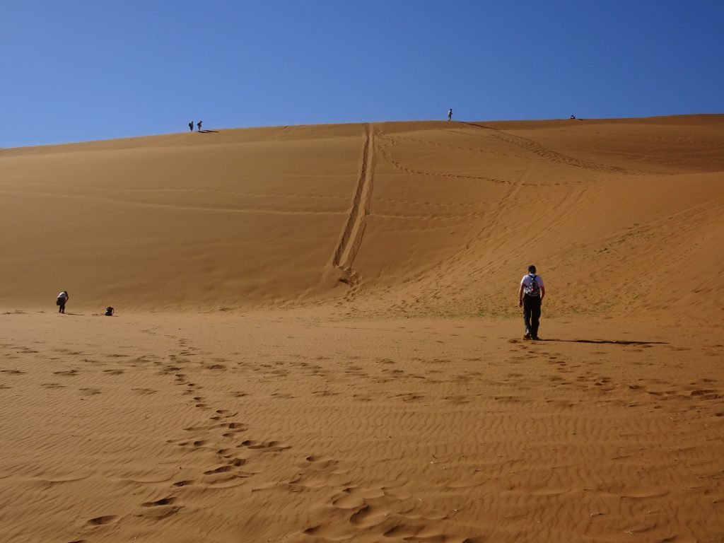 Climbing a dune in Namibia